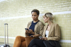 Female coworkers sitting at subway station